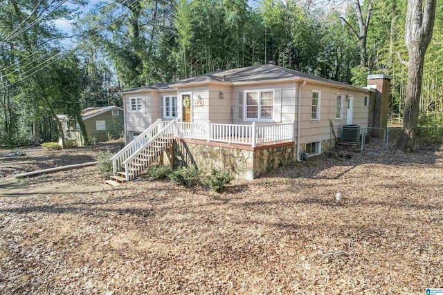 ranch-style house featuring a wooden deck and central AC