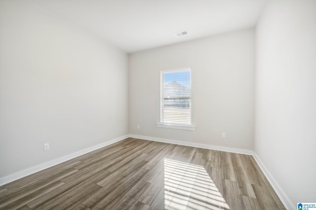 empty room with wood-type flooring