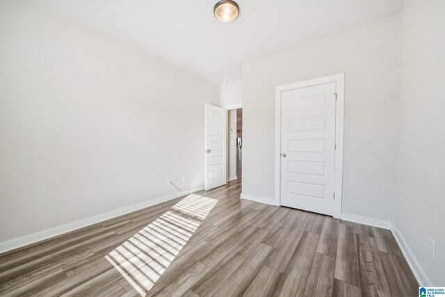 unfurnished room featuring wood-type flooring