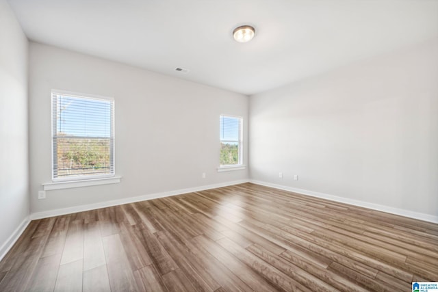 spare room featuring wood-type flooring