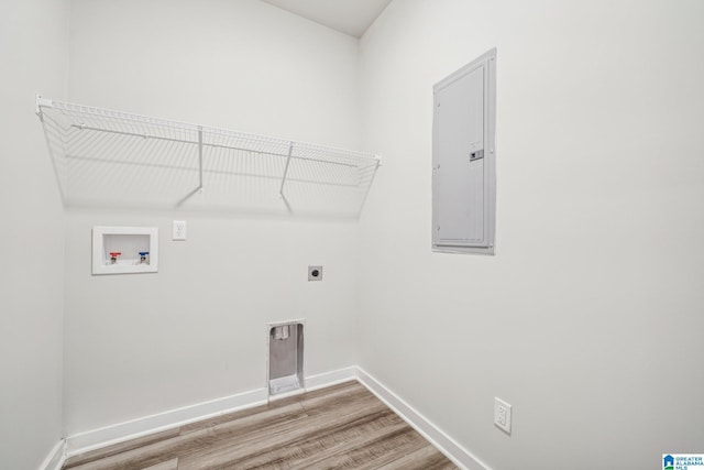 clothes washing area featuring hookup for a washing machine, electric panel, hookup for an electric dryer, and hardwood / wood-style flooring