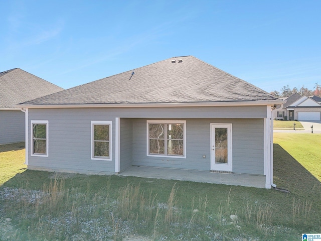 rear view of property featuring a patio and a lawn