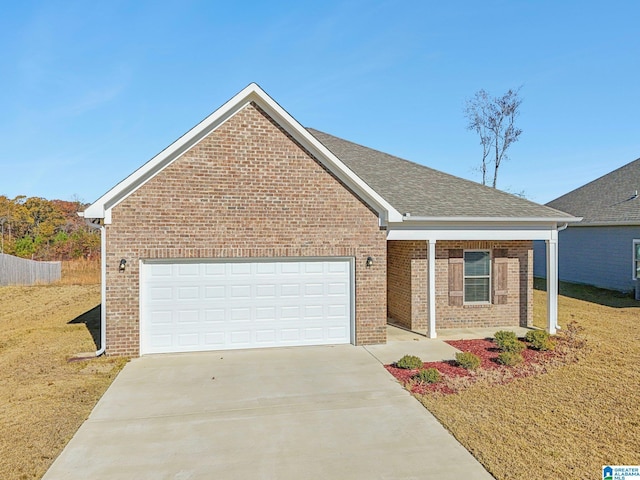 view of front of property featuring a garage and a front lawn