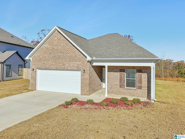 view of front of property featuring a garage and a front lawn