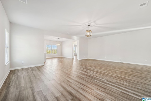 unfurnished room with light hardwood / wood-style flooring