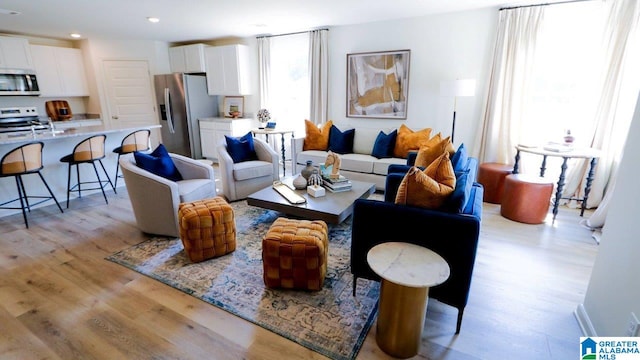 living room with sink and light hardwood / wood-style flooring