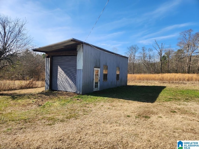 view of outbuilding with a yard