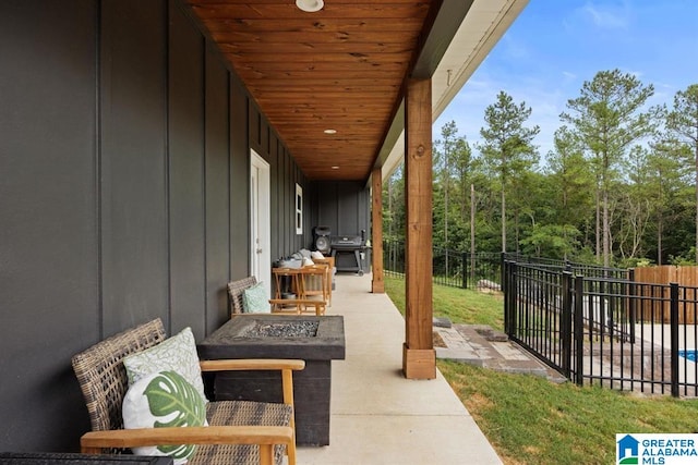 view of patio with area for grilling and a fire pit