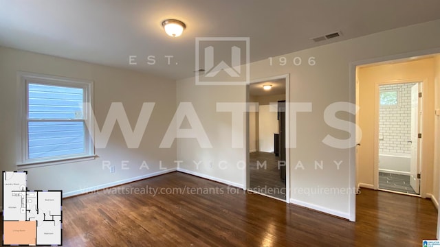 unfurnished room featuring a healthy amount of sunlight and dark hardwood / wood-style flooring