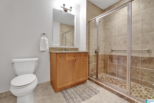 bathroom with an enclosed shower, vanity, tile patterned floors, and toilet