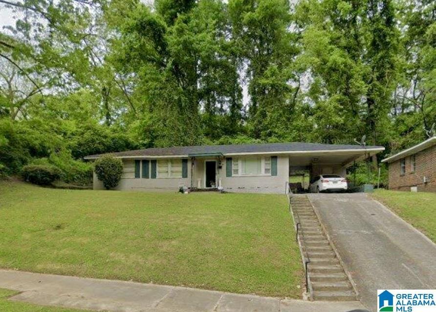 single story home with a carport and a front lawn