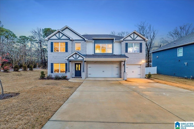 view of front of house with a garage and a yard