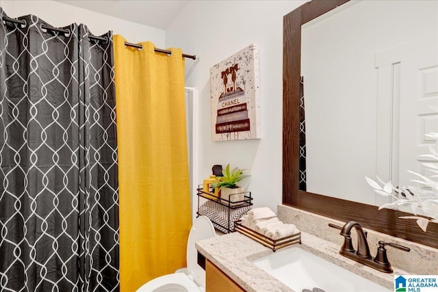 bathroom featuring vanity, toilet, and walk in shower