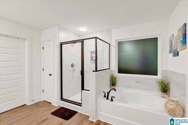 bathroom with shower with separate bathtub and hardwood / wood-style floors