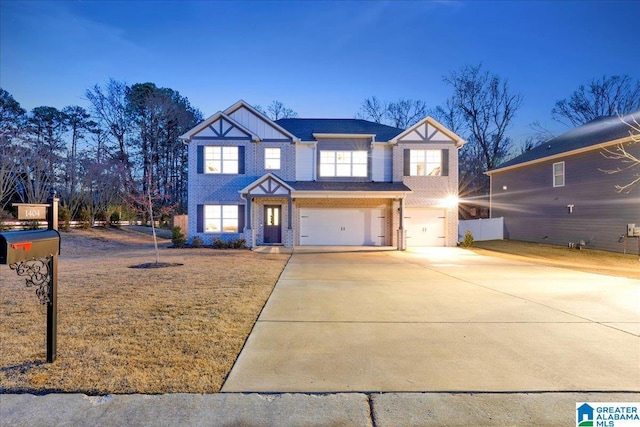 view of front of house with a garage and a lawn