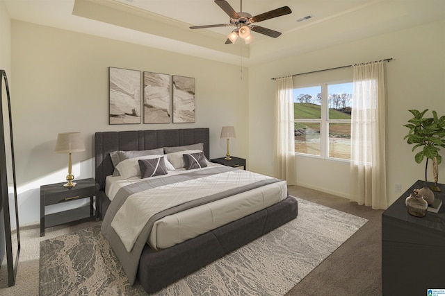 bedroom featuring carpet floors, ceiling fan, and a tray ceiling