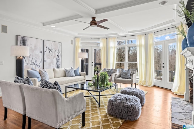 living room featuring french doors, coffered ceiling, ornamental molding, beamed ceiling, and hardwood / wood-style floors