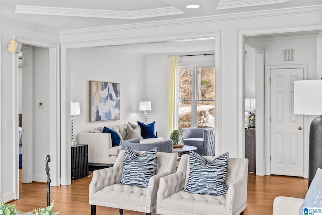 living room featuring wood-type flooring and crown molding