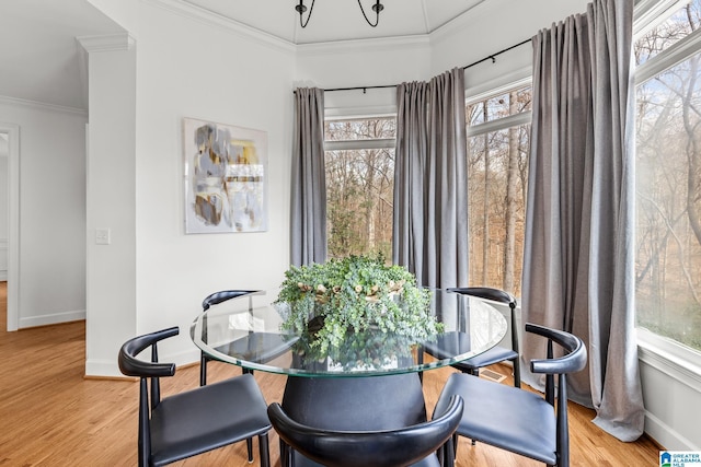 dining area with hardwood / wood-style flooring and ornamental molding