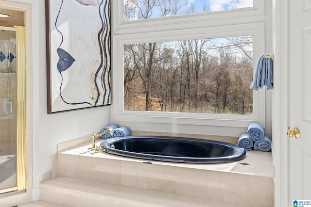 bathroom featuring a relaxing tiled tub