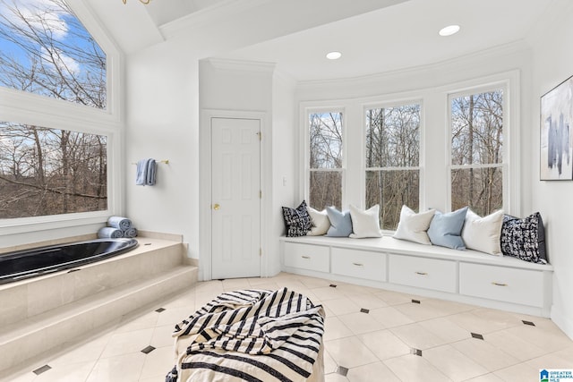 bathroom with crown molding, tiled bath, and tile patterned floors