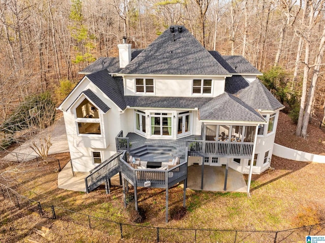 rear view of property featuring a deck and a patio area