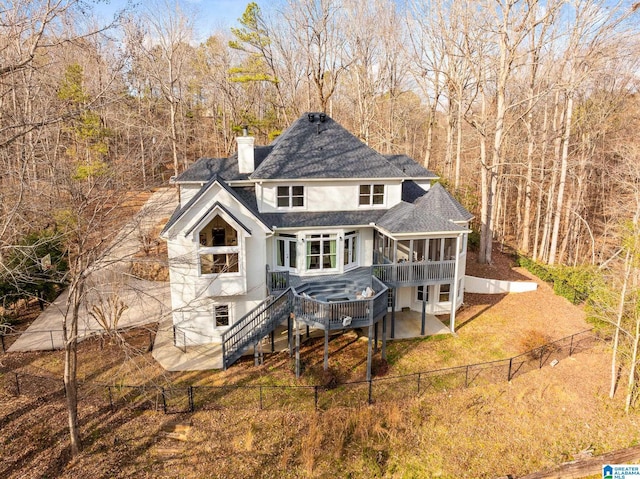 back of house featuring a patio area, a sunroom, and a deck