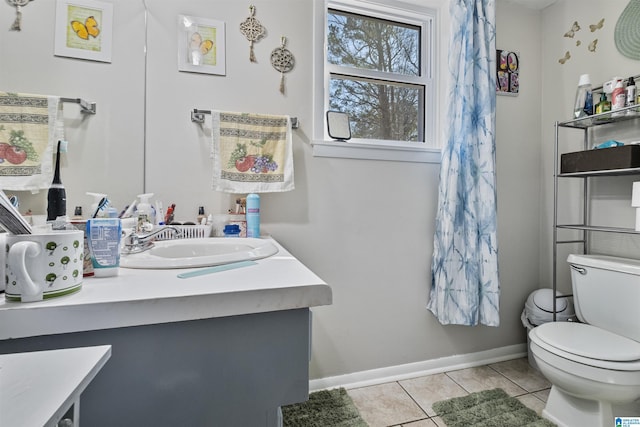 bathroom with tile patterned flooring, vanity, and toilet