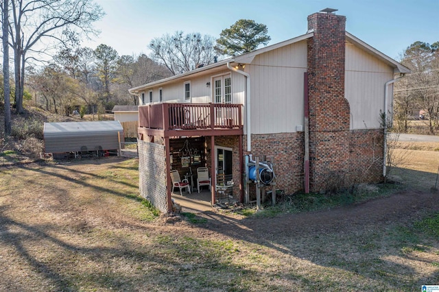 rear view of property with a carport and a deck