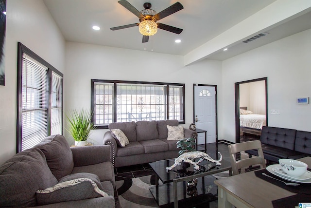 living room featuring ceiling fan and beam ceiling