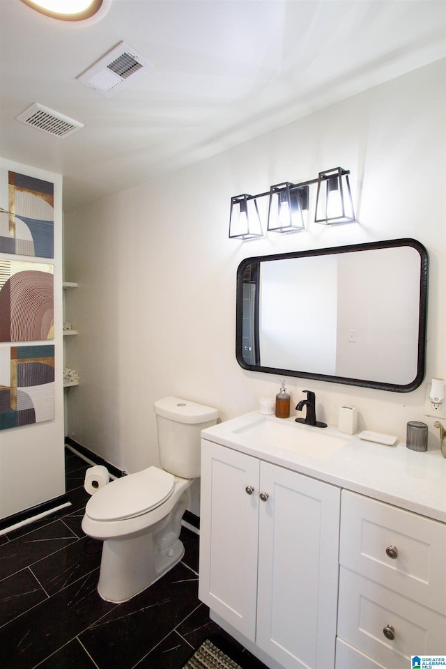 bathroom featuring vanity and toilet