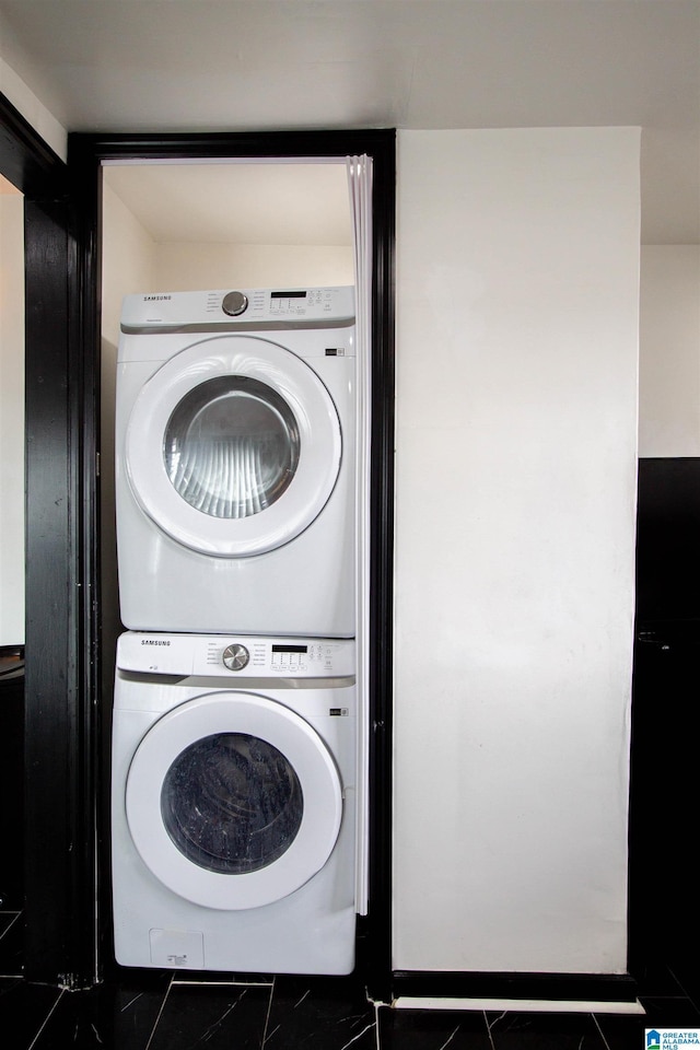 washroom featuring stacked washer / drying machine