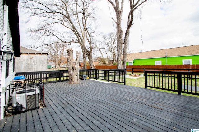 wooden deck featuring central AC and a lawn