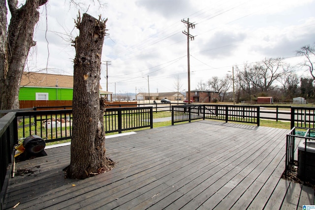 wooden deck featuring a yard and central air condition unit