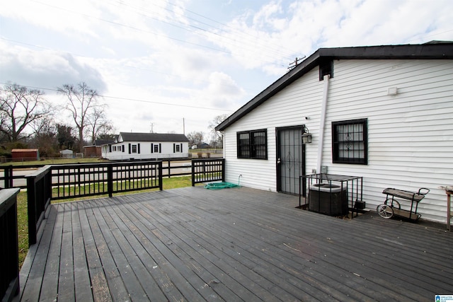 wooden terrace with cooling unit and a yard