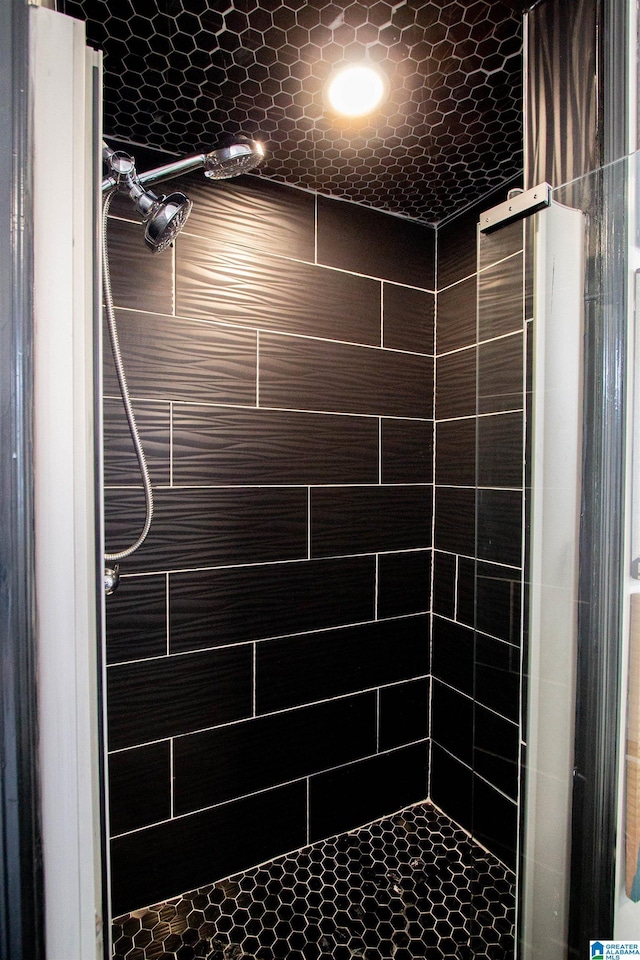 bathroom with a tile shower