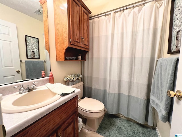 bathroom with a shower with curtain, tile patterned floors, vanity, and toilet