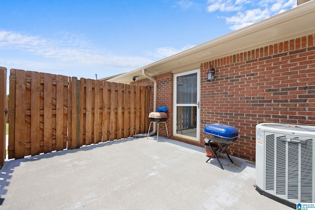 view of patio with area for grilling and central air condition unit