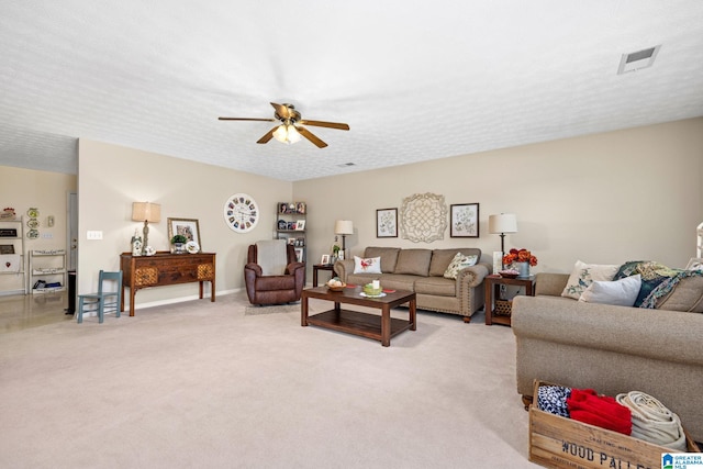 living room with light carpet, a textured ceiling, and ceiling fan