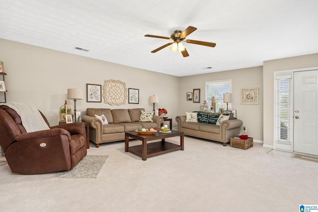 carpeted living room featuring ceiling fan