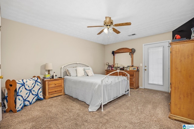 bedroom featuring ceiling fan, carpet flooring, and a textured ceiling