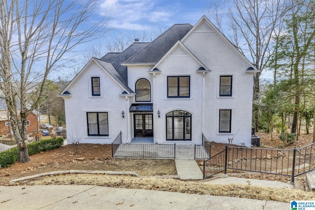 french country style house with central AC unit and french doors