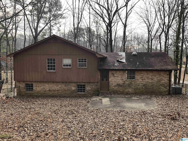 rear view of house with cooling unit and a patio