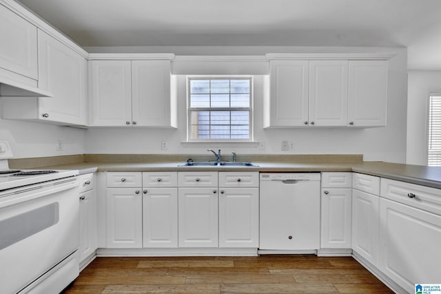 kitchen with sink, white cabinets, plenty of natural light, white appliances, and light hardwood / wood-style flooring