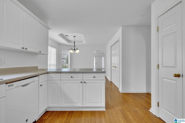 kitchen with white cabinetry, a tray ceiling, dishwasher, and pendant lighting