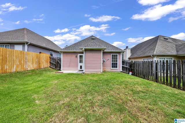 back of house with a yard