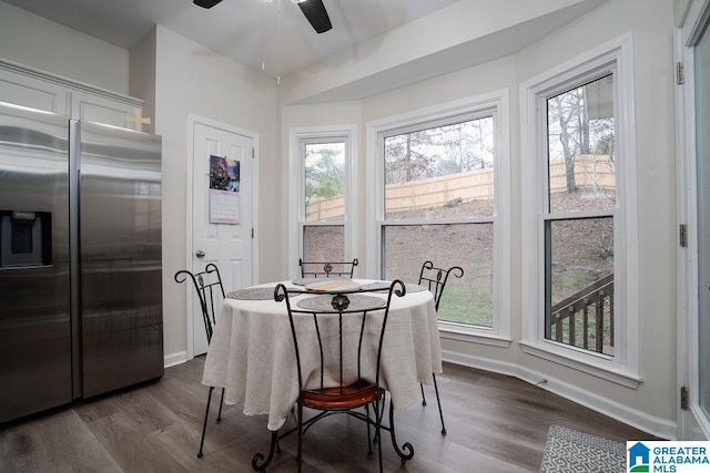 dining space with ceiling fan, a healthy amount of sunlight, and dark hardwood / wood-style floors