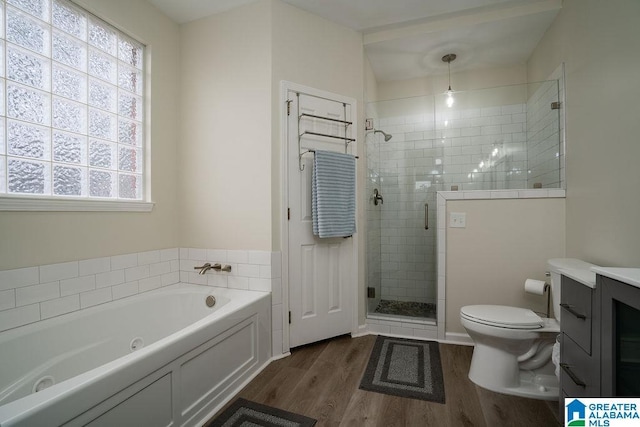 full bathroom with vanity, hardwood / wood-style floors, plus walk in shower, and toilet