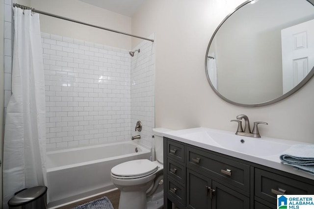 full bathroom with vanity, shower / tub combo with curtain, and toilet