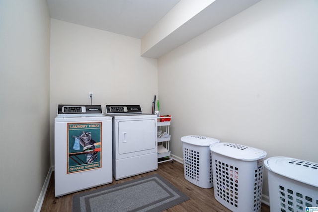 laundry area with dark hardwood / wood-style floors and washer and clothes dryer